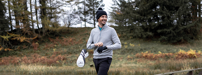 male golfer in a grey Glenmuir zip neck knitted sweater