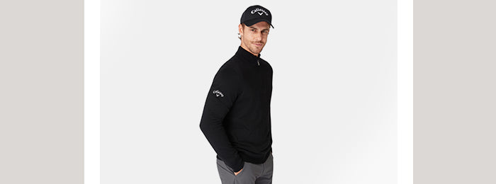 Model wearing black men's lined thermal sweater from Callaway Golf