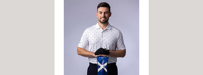 Male model in Glenmuir short sleeve print polo shirt and scottish flag design club head cover