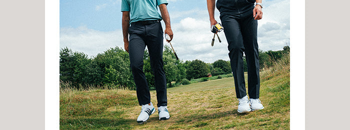 Two golfers wearing adidas mens golf trousers