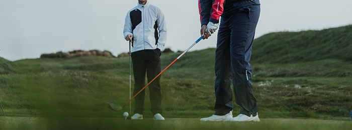 Male golfers on the green in galvin green waterproof trousers