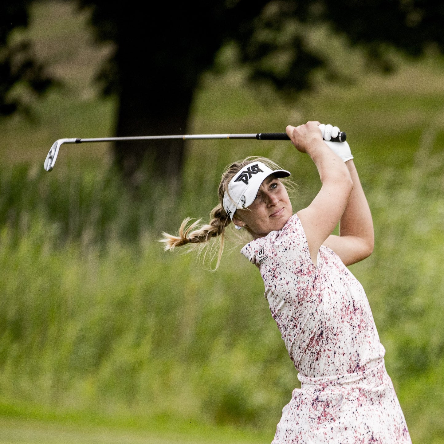 Female golfer completing her shot in the Abacus Ladies DryCool Cap Sleeve Polo - Soft, Stretch & Sun-Smart