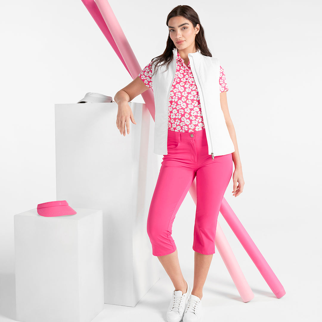 Greem Lamb's pink and white daisy print polo combined with a white gilet and pink capris available at GolfGarb