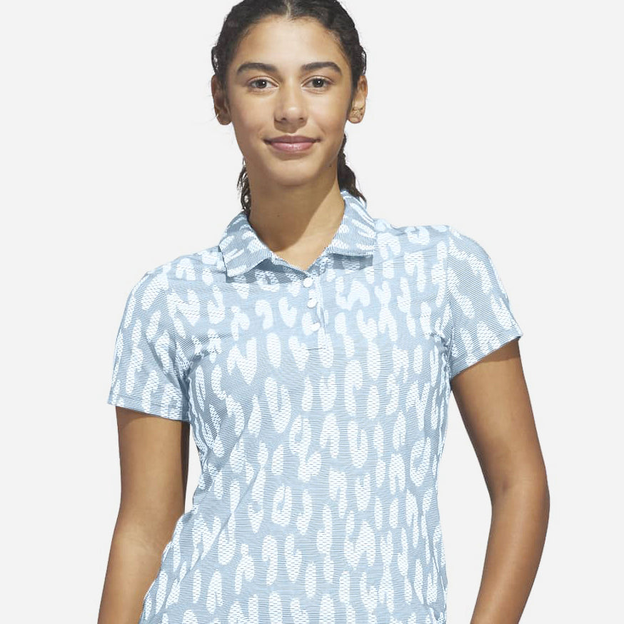 Model wearing the adidas golf textured leopard print short sleeve polo in pale blue and white