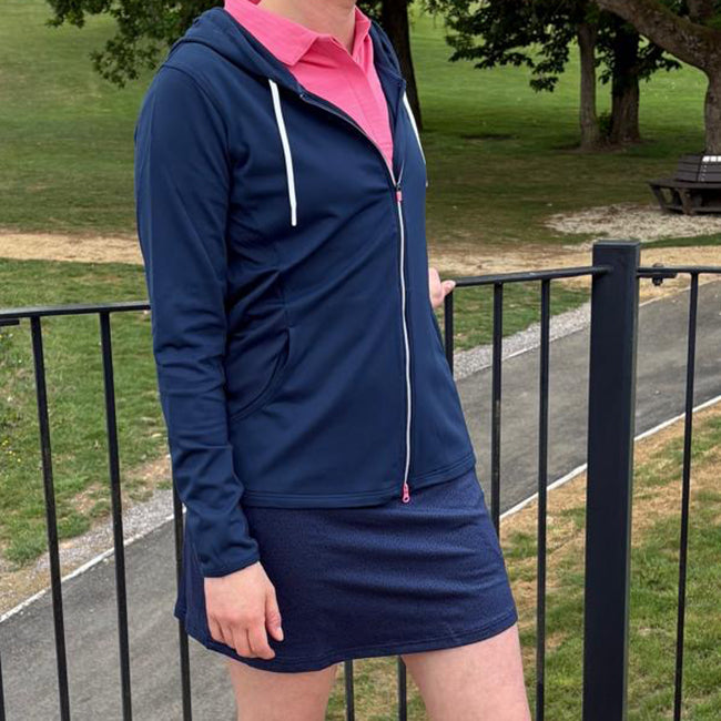 Carolyn wears the Footjoy navy full zip soft jersey mid layer hooded jacket with pink zip detail from GolfGarb