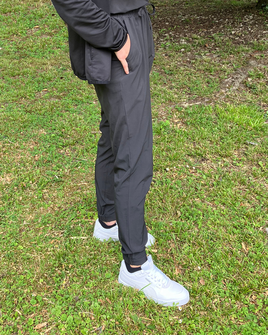 Portia wearing the Puma Golf women's Cali G spikeless golf shoe and Puma black golf trousers