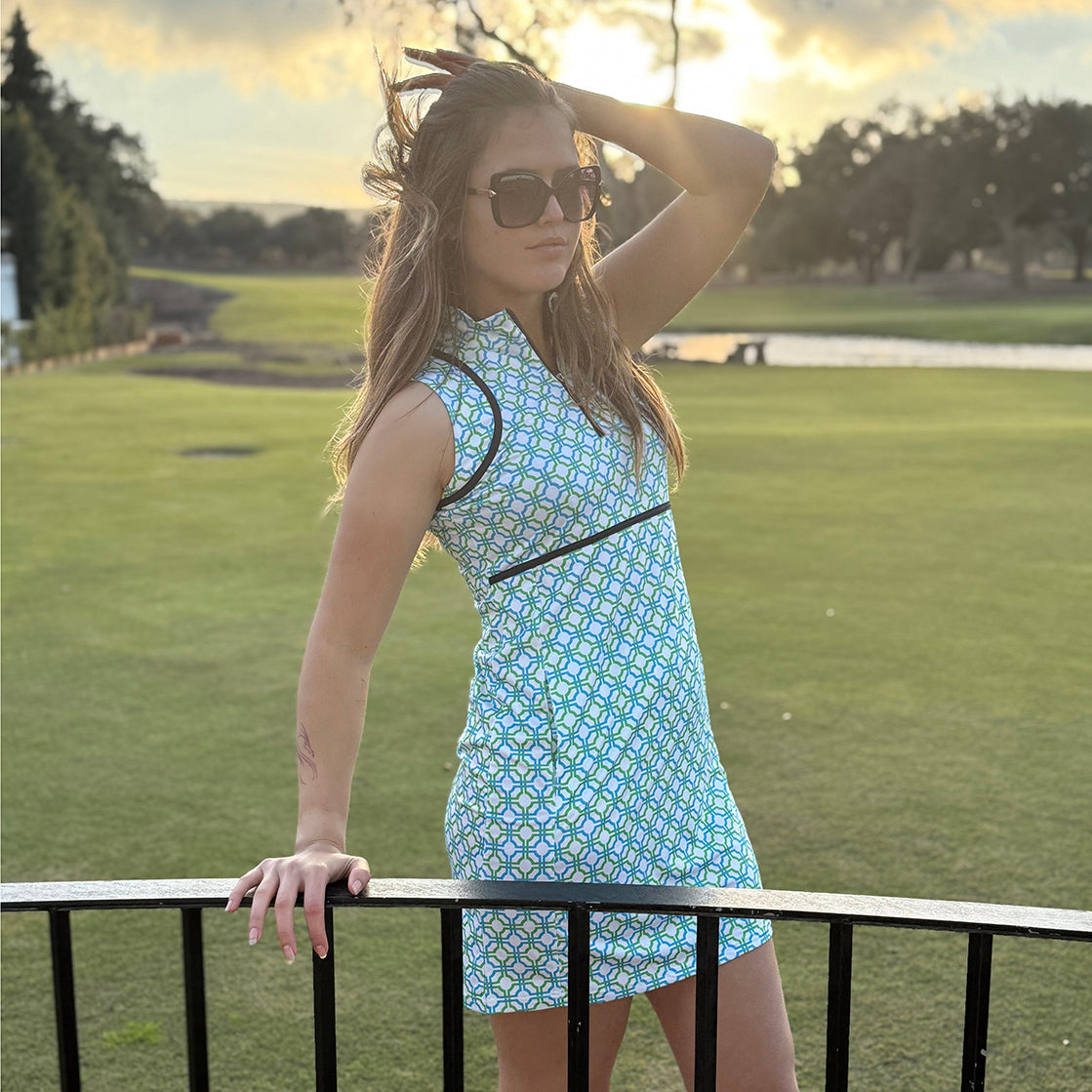 Woman in a Swing out Sister Golf mosaic tile print dress standing on a golf course