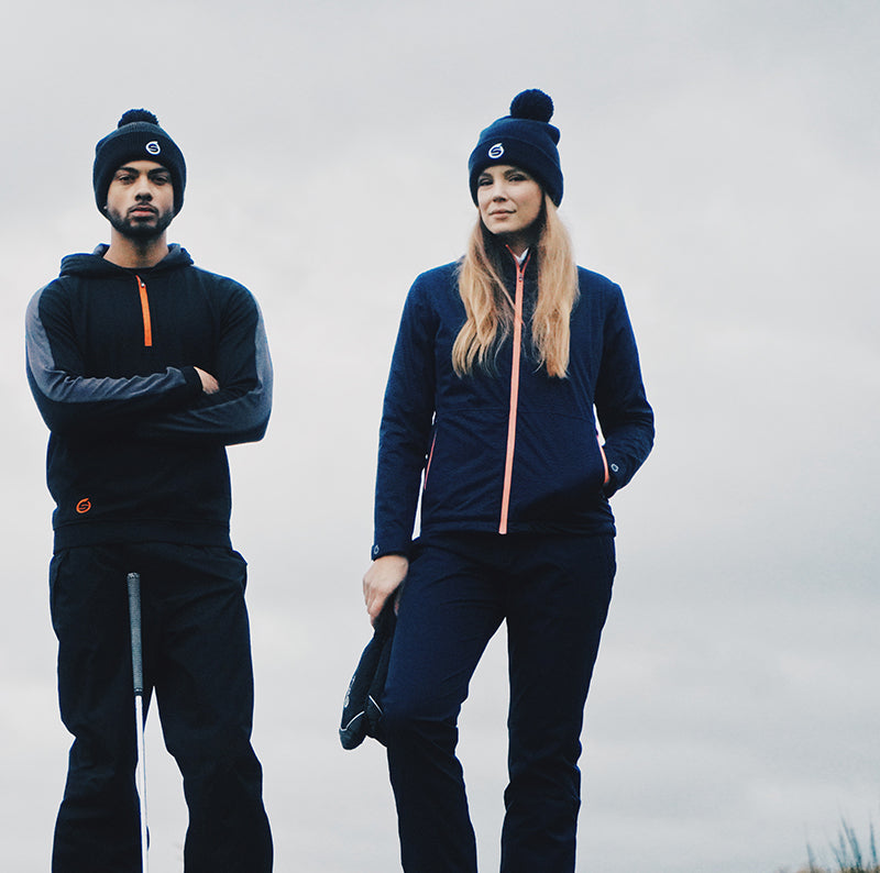 Golfers wearing Sunderland of Scotland Men's and women's golf trousers, hoodie and weatherproof jacket
