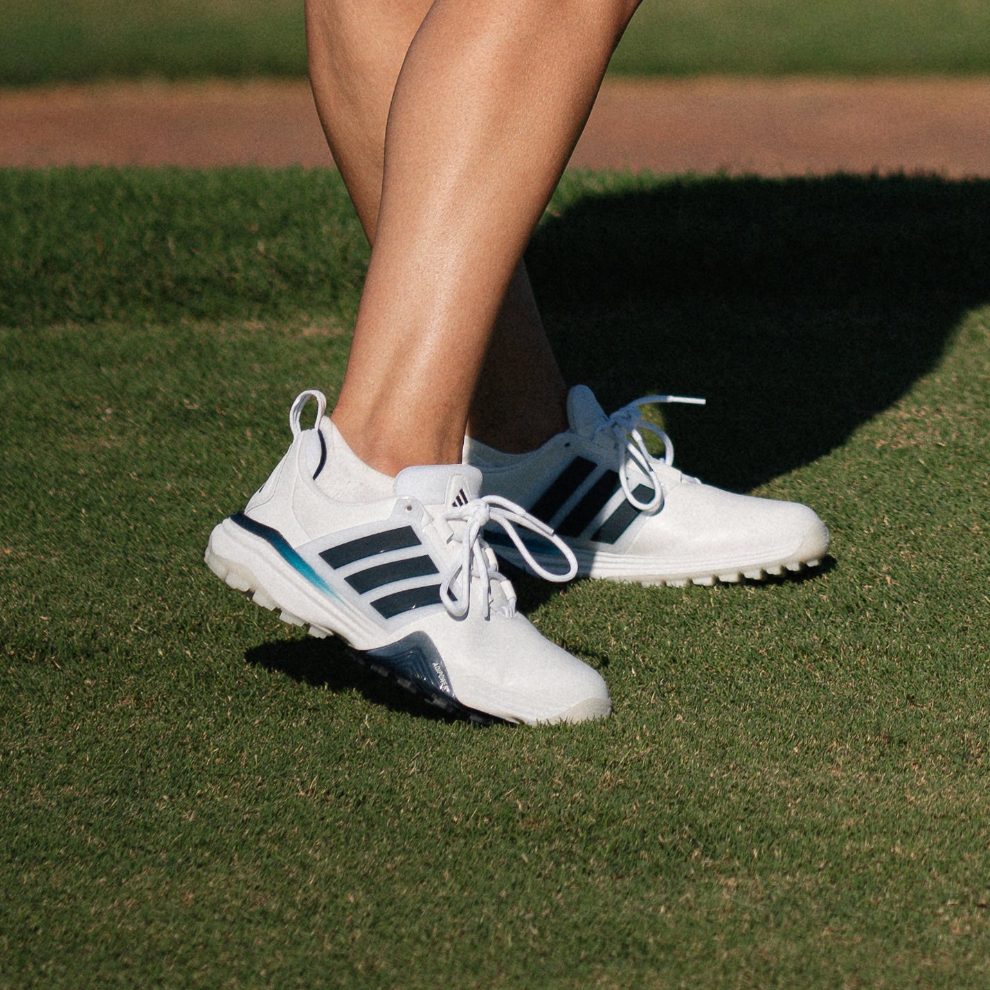 close up of a golfer wearing adidas Women's Waterproof Adipower 26 Spikeless Golf Shoes With Excellent Stability and Control