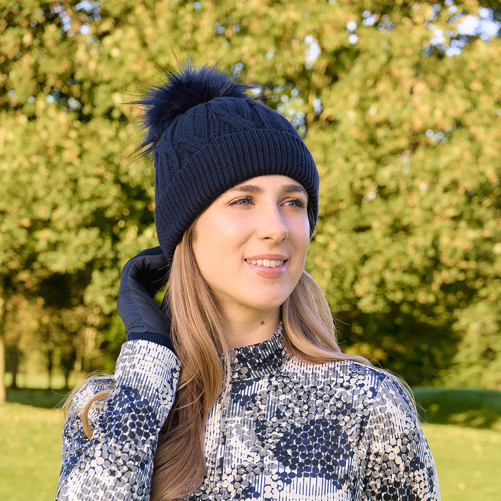 Pure Golf Ladies Lined Waterproof Bobble Hat with Cable Knit Design in Navy